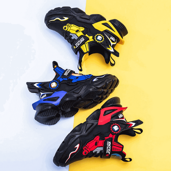 Colorful boys athletic sneakers in black with yellow, blue, and red accents on white and yellow background